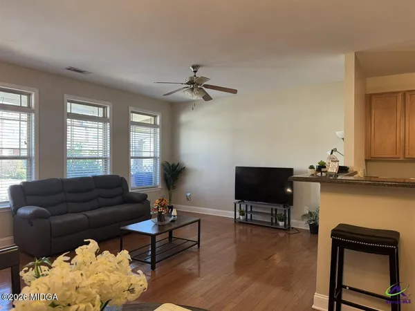 a living room with furniture and a flat screen tv