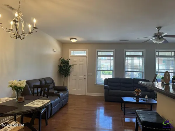 a living room with furniture and wooden floor