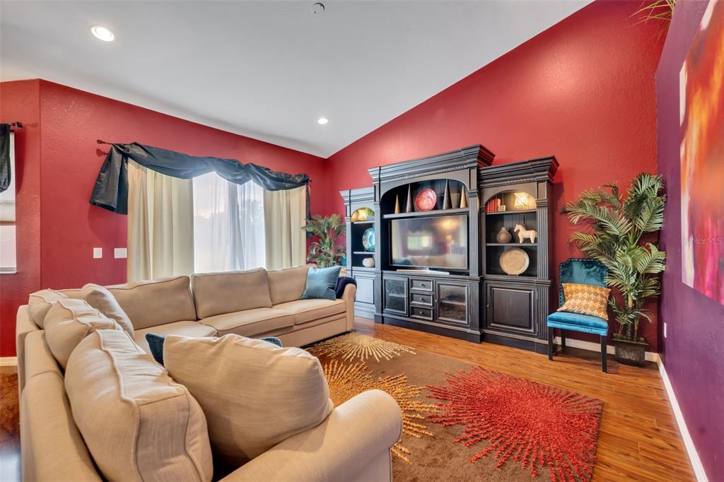 4946 Northeast 124th Road Oxford, FL 34484 - Photo 24 of 69 a living room with furniture and a flat screen tv