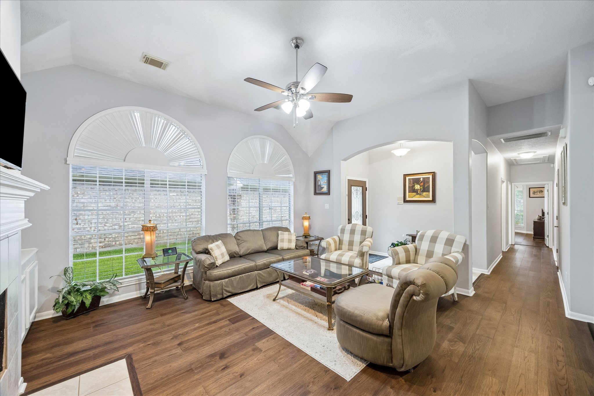 12423 Rutgers Park Court Houston, TX 77058 - Photo 5 of 29 a living room with furniture a fireplace and a chandelier
