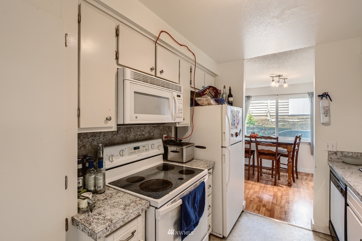3325 Rockefeller Avenue Everett, WA 98201 - Photo 17 of 32 a kitchen with stainless steel appliances granite countertop a stove and a refrigerator