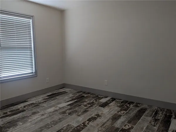 a white toilet and tub sitting next to a window