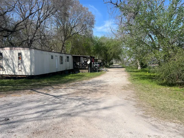 a view of a backyard with large trees