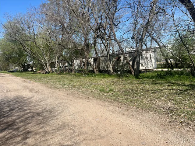 a view of a field with trees