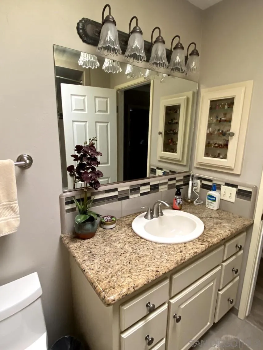 10835 Singletree Lane Spring Valley, CA 91978 - Photo 18 of 31 a bathroom with a double vanity sink and a mirror