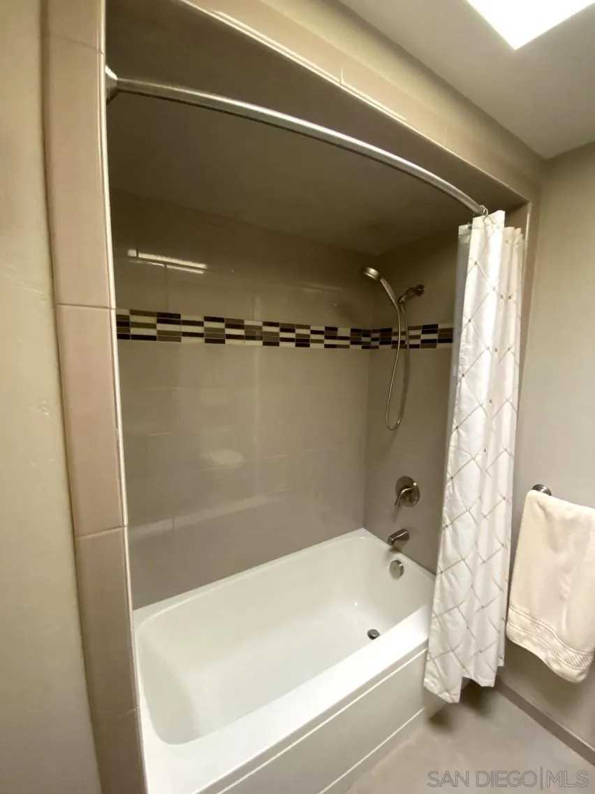 10835 Singletree Lane Spring Valley, CA 91978 - Photo 20 of 31 a bathroom with a tub and shower