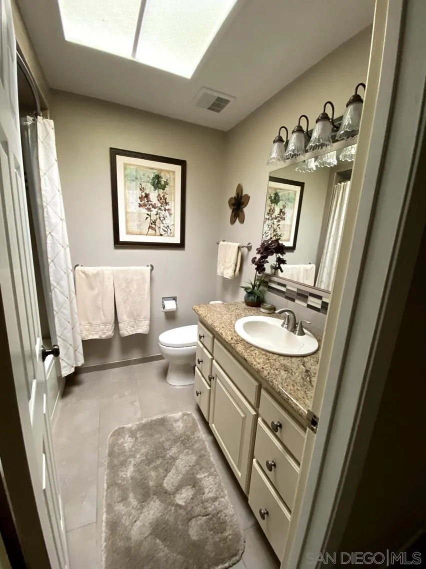 10835 Singletree Lane Spring Valley, CA 91978 - Photo 21 of 31 a bathroom with a sink double vanity granite and a mirror
