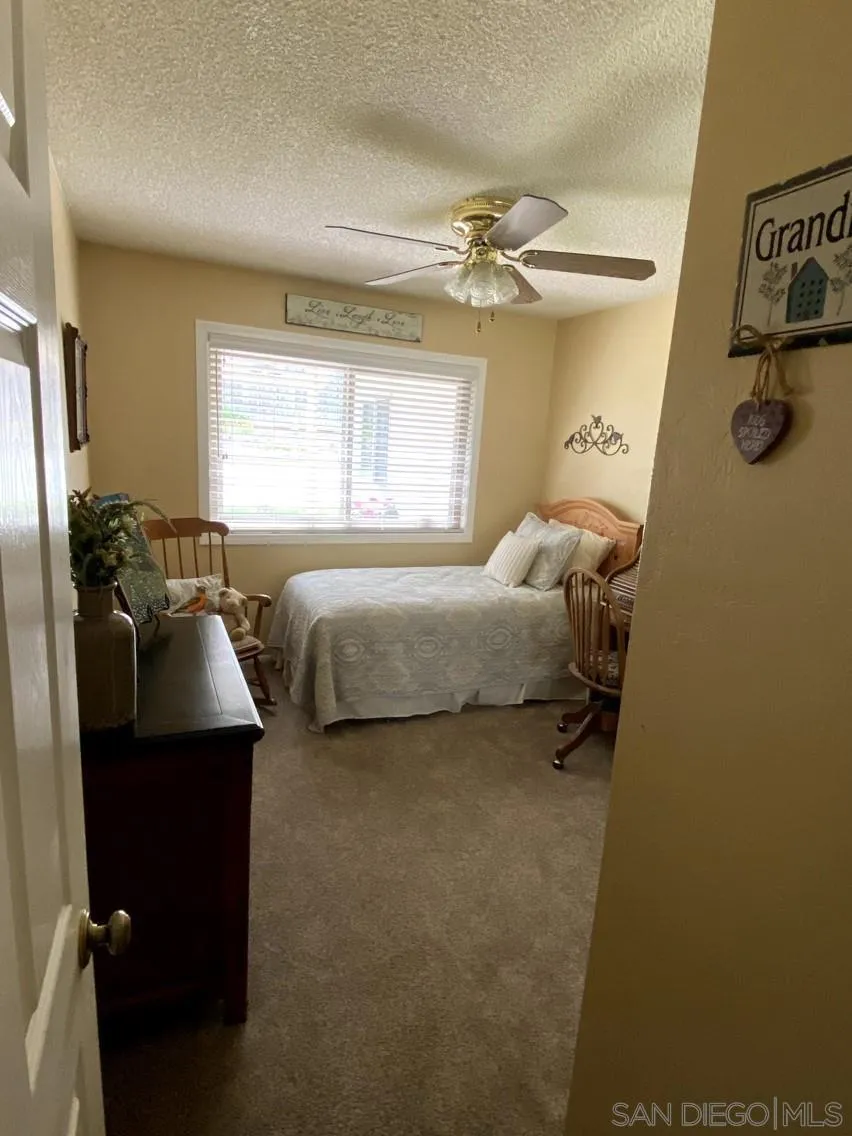 10835 Singletree Lane Spring Valley, CA 91978 - Photo 27 of 31 a bedroom with a bed and a window