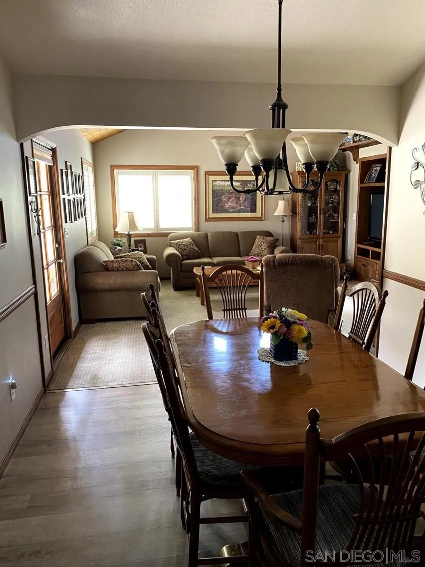 10835 Singletree Lane Spring Valley, CA 91978 - Photo 28 of 31 a view of a dining room with furniture and wooden floor