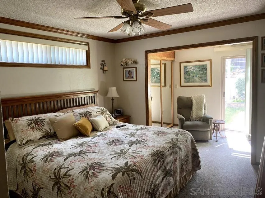 10835 Singletree Lane Spring Valley, CA 91978 - Photo 3 of 31 a bedroom with a bed and wooden floor