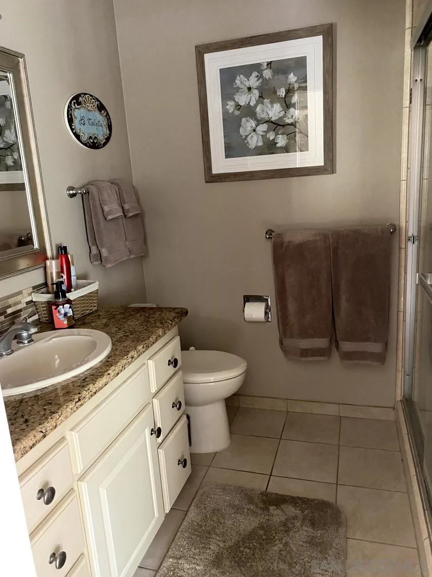 10835 Singletree Lane Spring Valley, CA 91978 - Photo 8 of 31 a bathroom with a toilet sink and mirror