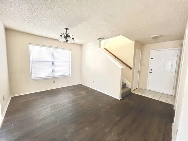 an empty room with windows and entryway