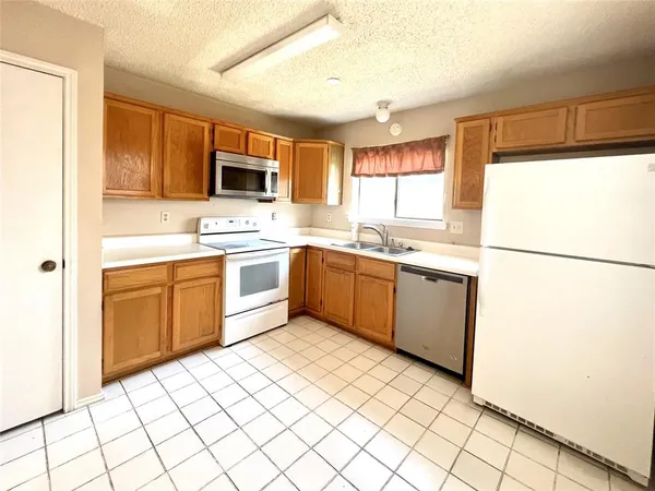 a kitchen with a sink appliances and cabinets