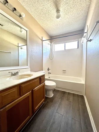 a bathroom with a double vanity sink toilet and shower