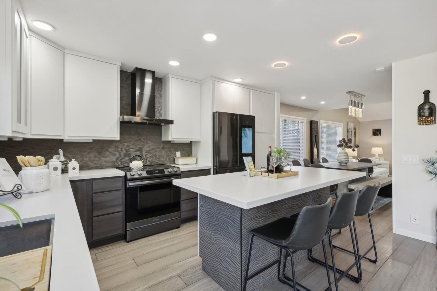 201 Prague Drive San Jose, CA 95119 - Photo 16 of 77 a kitchen with stainless steel appliances kitchen island granite countertop a table chairs sink and cabinets