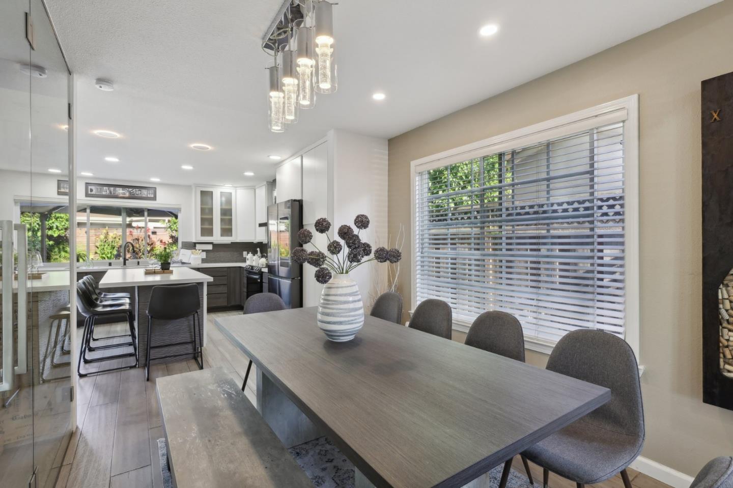 201 Prague Drive San Jose, CA 95119 - Photo 18 of 77 a dining room with kitchen island furniture a chandelier and kitchen view