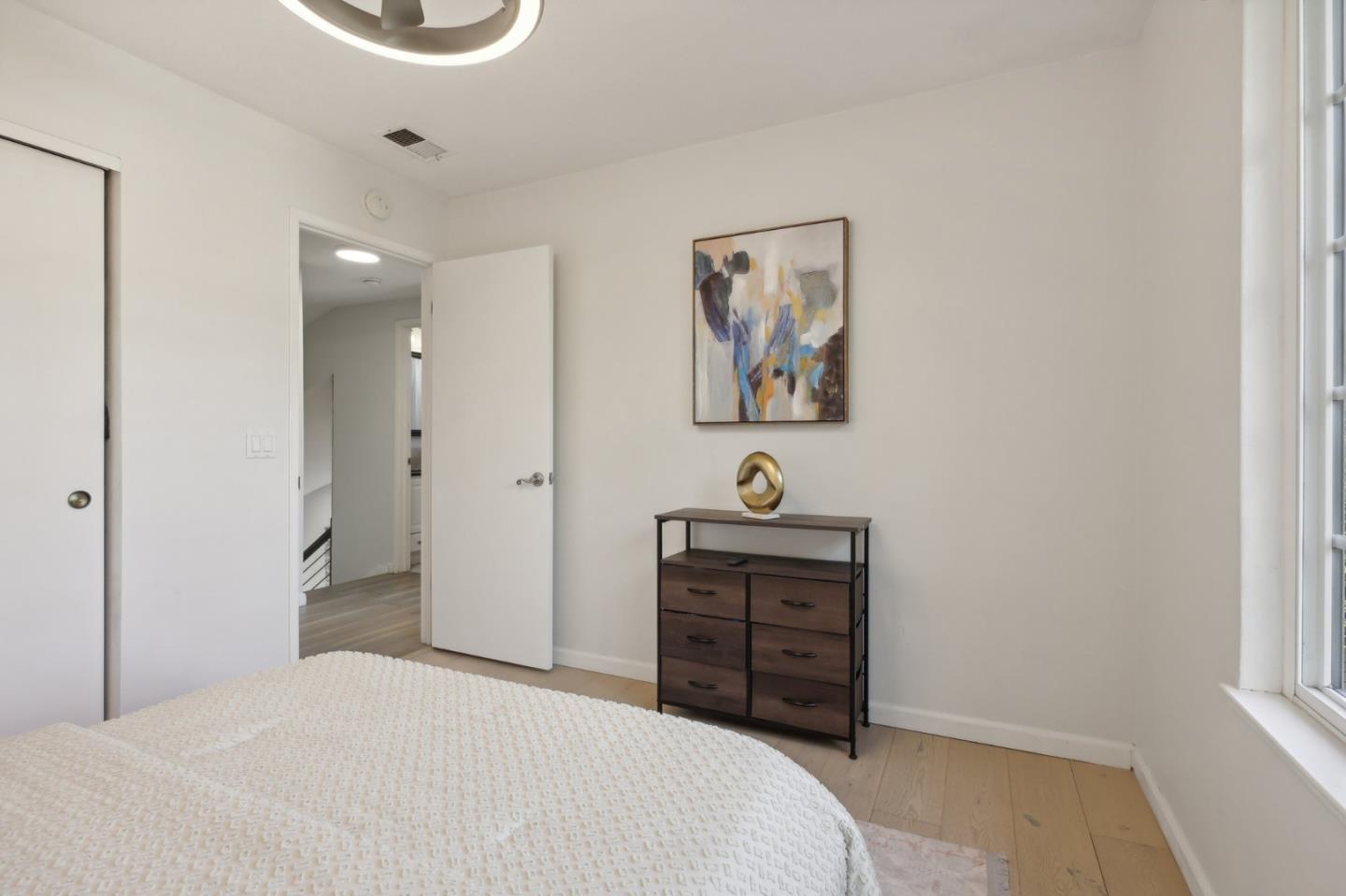 201 Prague Drive San Jose, CA 95119 - Photo 45 of 77 a bedroom with a bed and a chandelier