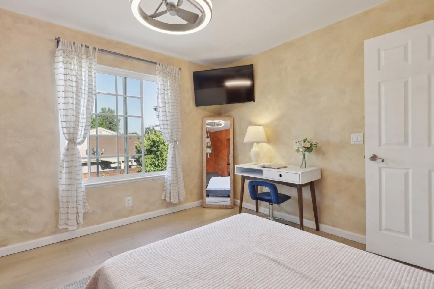 201 Prague Drive San Jose, CA 95119 - Photo 48 of 77 a living room with a table chairs and a flat screen tv