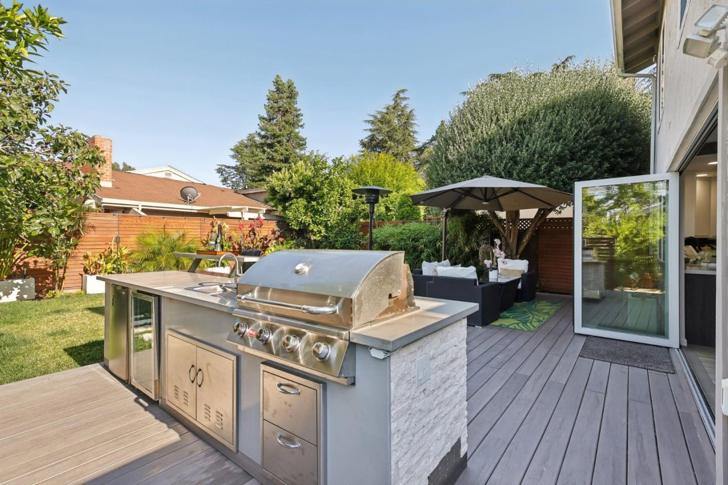 201 Prague Drive San Jose, CA 95119 - Photo 57 of 77 a view of a deck with table and chairs under an umbrella with wooden floor