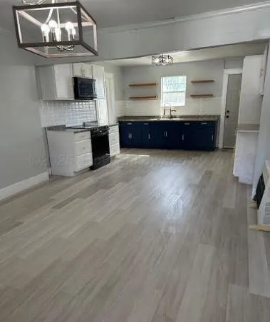 a view of kitchen and wooden floor