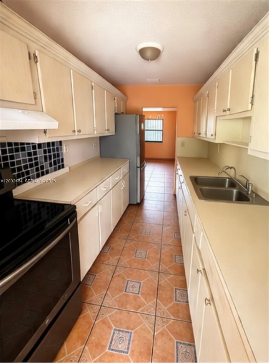 a kitchen with a sink and cabinets