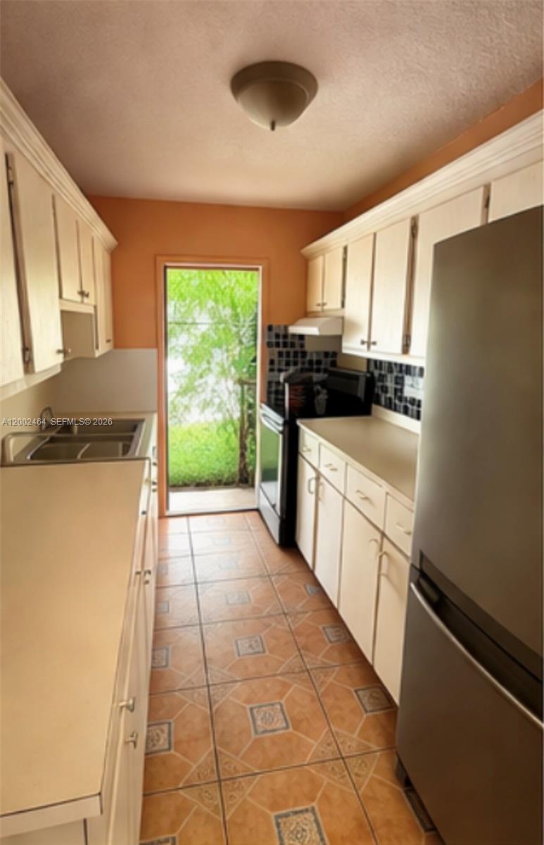 185 Northwest 82nd Street, Unit 1 Miami, FL 33150 - Photo 2 of 13 a kitchen with stainless steel appliances granite countertop a stove a sink and a refrigerator