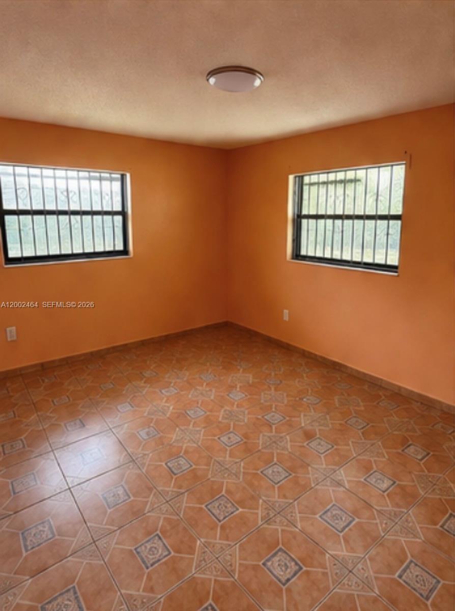 185 Northwest 82nd Street, Unit 1 Miami, FL 33150 - Photo 7 of 13 a view of an empty room with a window