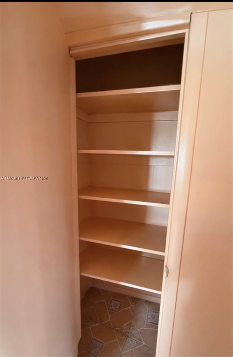 185 Northwest 82nd Street, Unit 1 Miami, FL 33150 - Photo 10 of 13 a view of walk in closet with empty racks