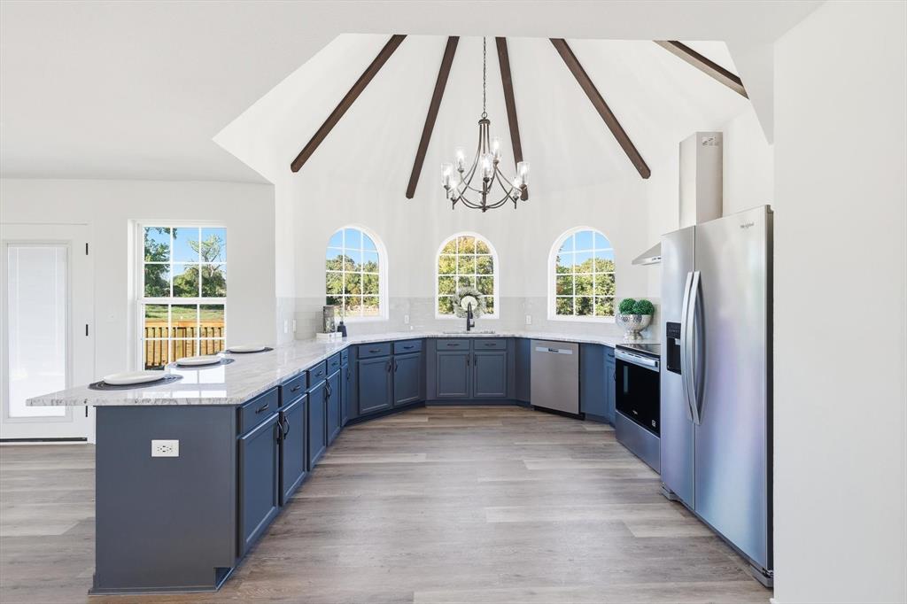 a kitchen with stainless steel appliances a refrigerator and a sink