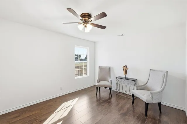 a view of a livingroom with furniture and hardwood floor