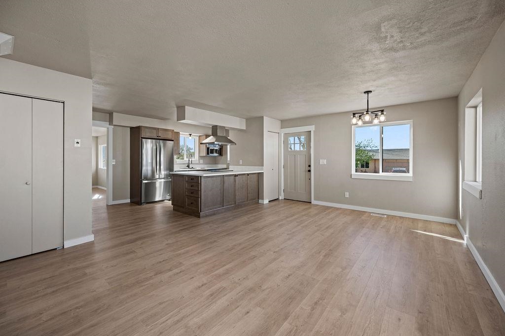 508 Rosa Street Palisade, CO 81526 - Photo 2 of 18 an empty room with wooden floor cabinet and windows