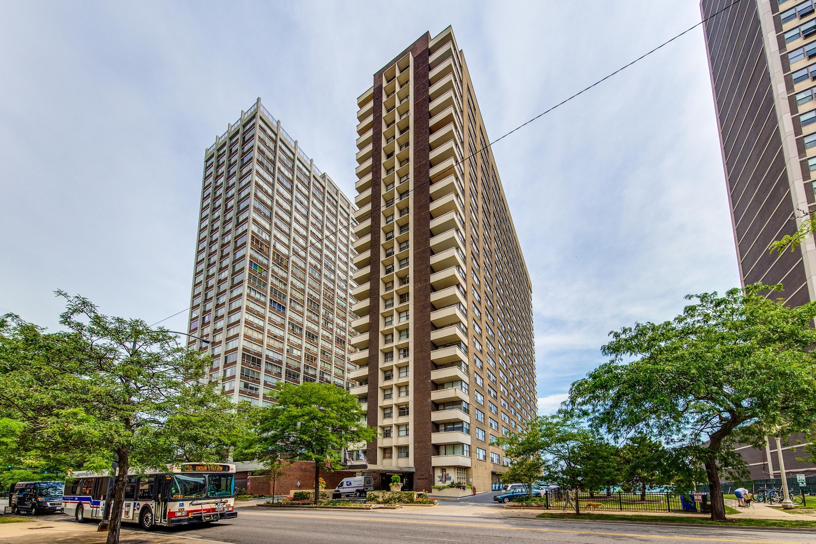 a view of a tall building next to a road