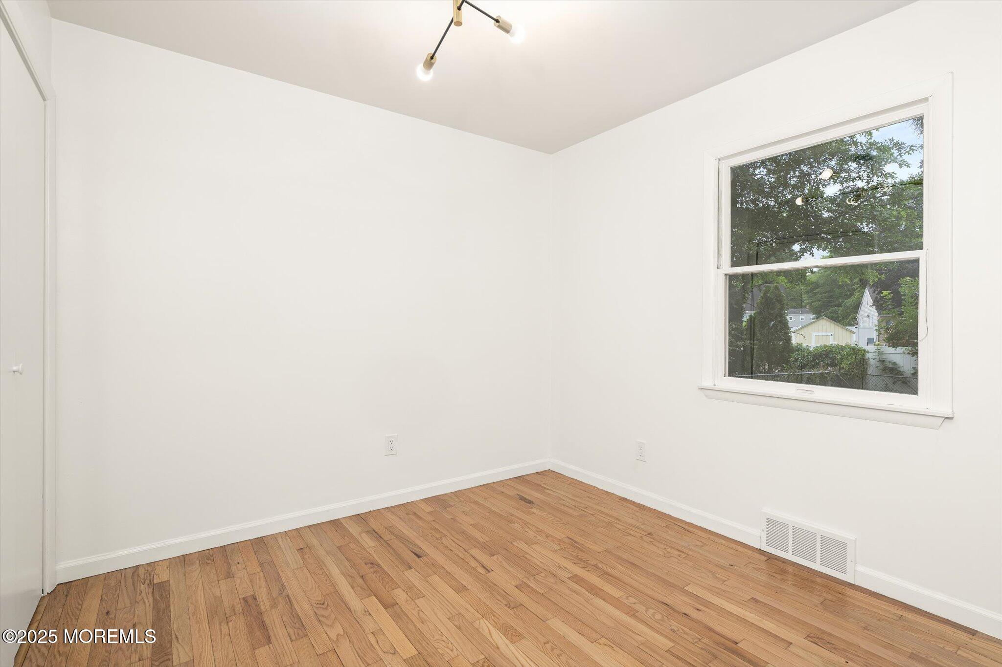 35 Waldron Road Allentown, NJ 08501 - Photo 17 of 39 an empty room with wooden floor and windows
