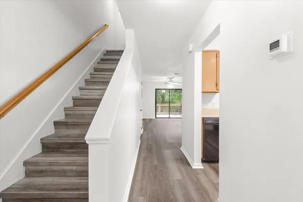 a view of entryway and hall with wooden floor
