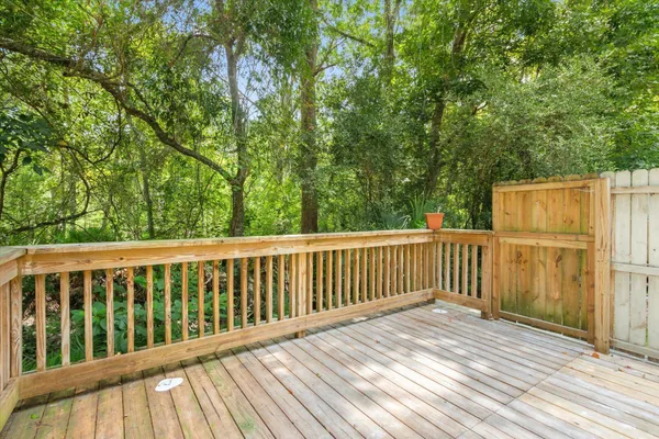 a balcony with wooden floor and fence