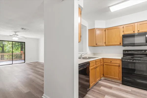 a kitchen with a sink stove and cabinets