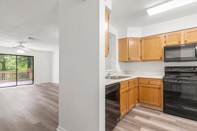 a kitchen with a sink stove and cabinets