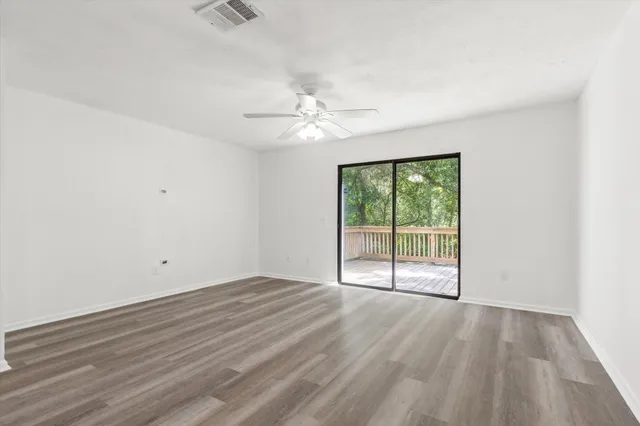 wooden floor in an empty room with a window