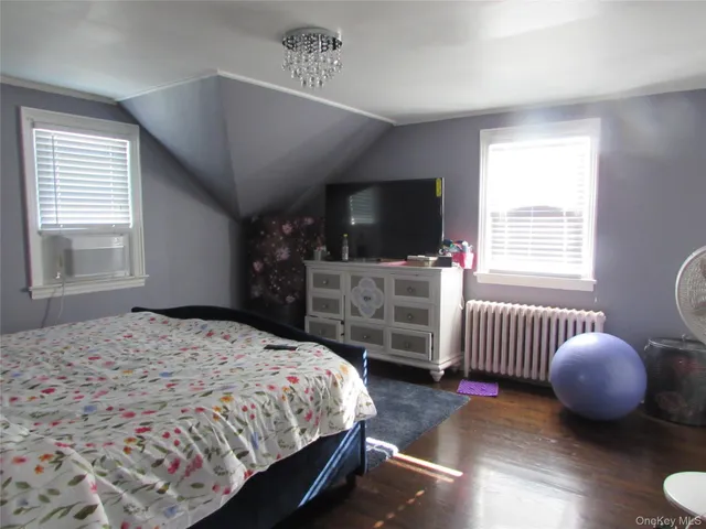 a bedroom with a bed and flat screen tv