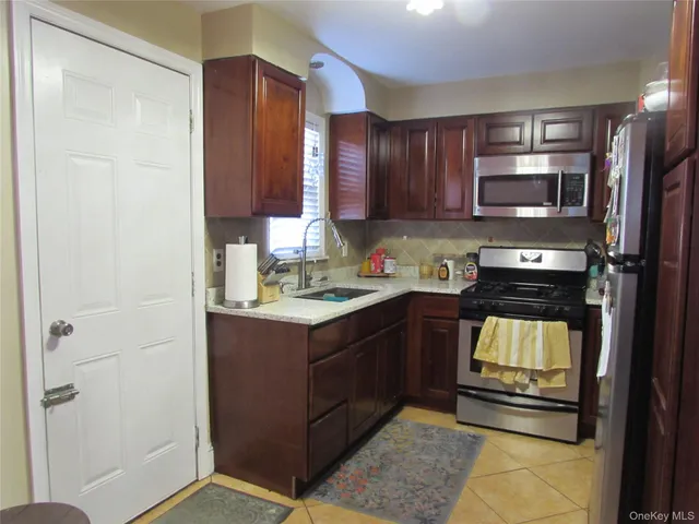 a kitchen with a refrigerator stove and sink