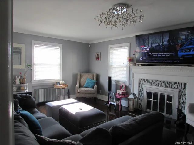 a living room with furniture a fireplace and a window