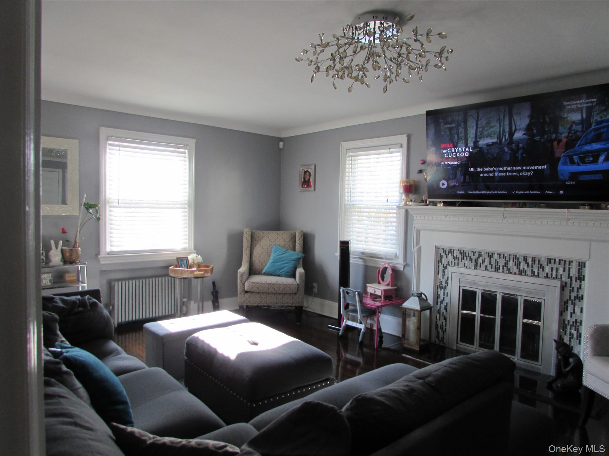 51 Phoenix Street Hempstead, NY 11550 - Photo 4 of 16 a living room with furniture a fireplace and a window