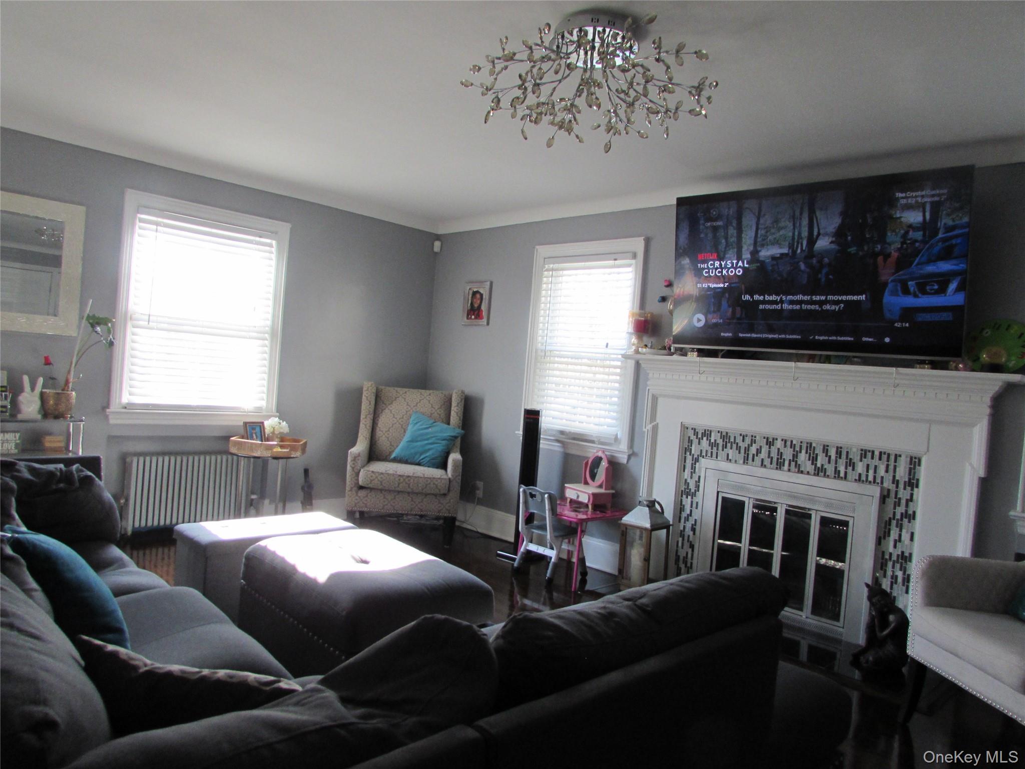 51 Phoenix Street Hempstead, NY 11550 - Photo 5 of 16 a living room with furniture a window and a fireplace
