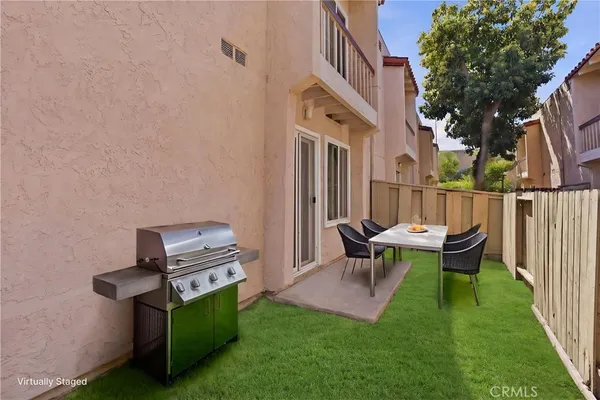 a view of backyard of house with outdoor seating