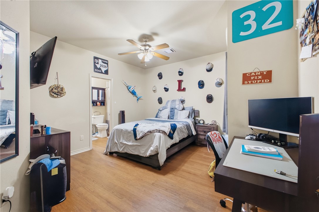 4400 Milam Street Bryan, TX 77801 - Photo 13 of 25 a bedroom with furniture and a flat screen tv