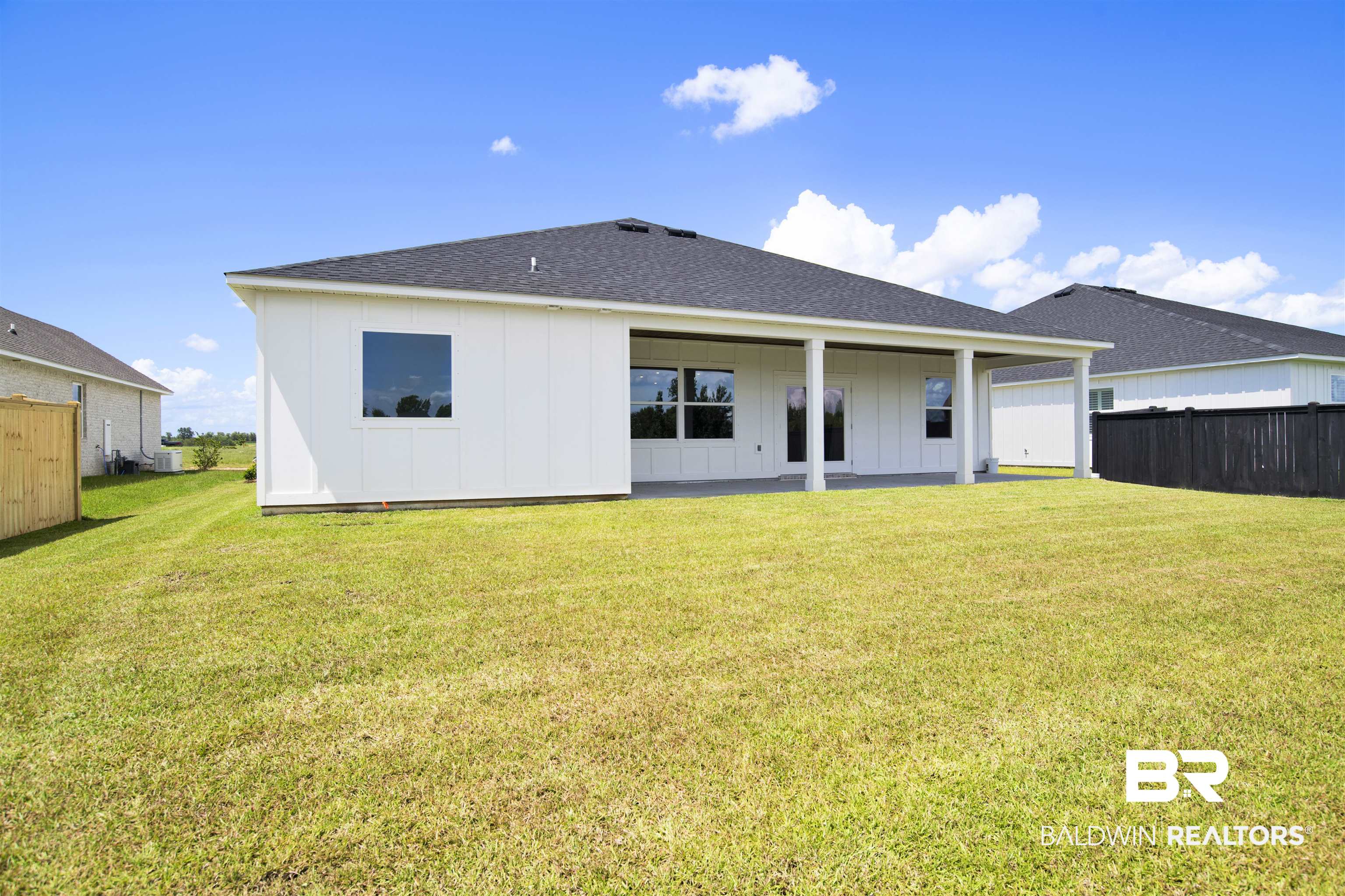 23852 Lafite Circle Daphne, AL 36526 - Photo 28 of 30 Rear view of house with board and batten siding and a shingled roof
