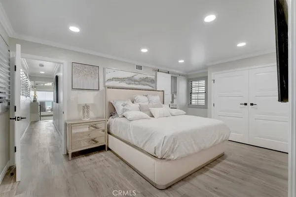 a large bedroom with a bed and a large window