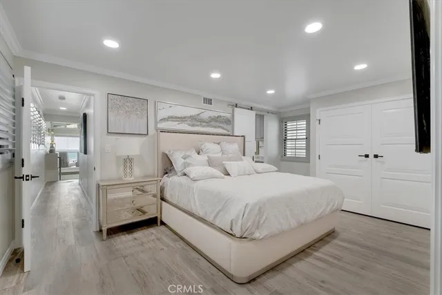 a large bedroom with a bed and a large window