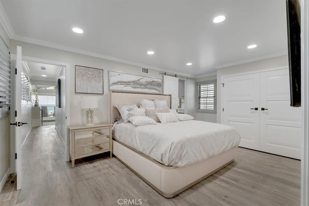 2808 West Oceanfront Newport Beach, CA 92663 - Photo 20 of 31 a large bedroom with a bed and a large window