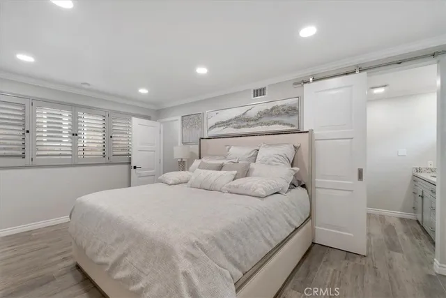 a bedroom with a large bed and a window